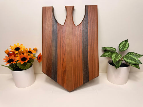Handmade charcuterie serving board in cherry wood with walnut side accents, U-shaped cutouts