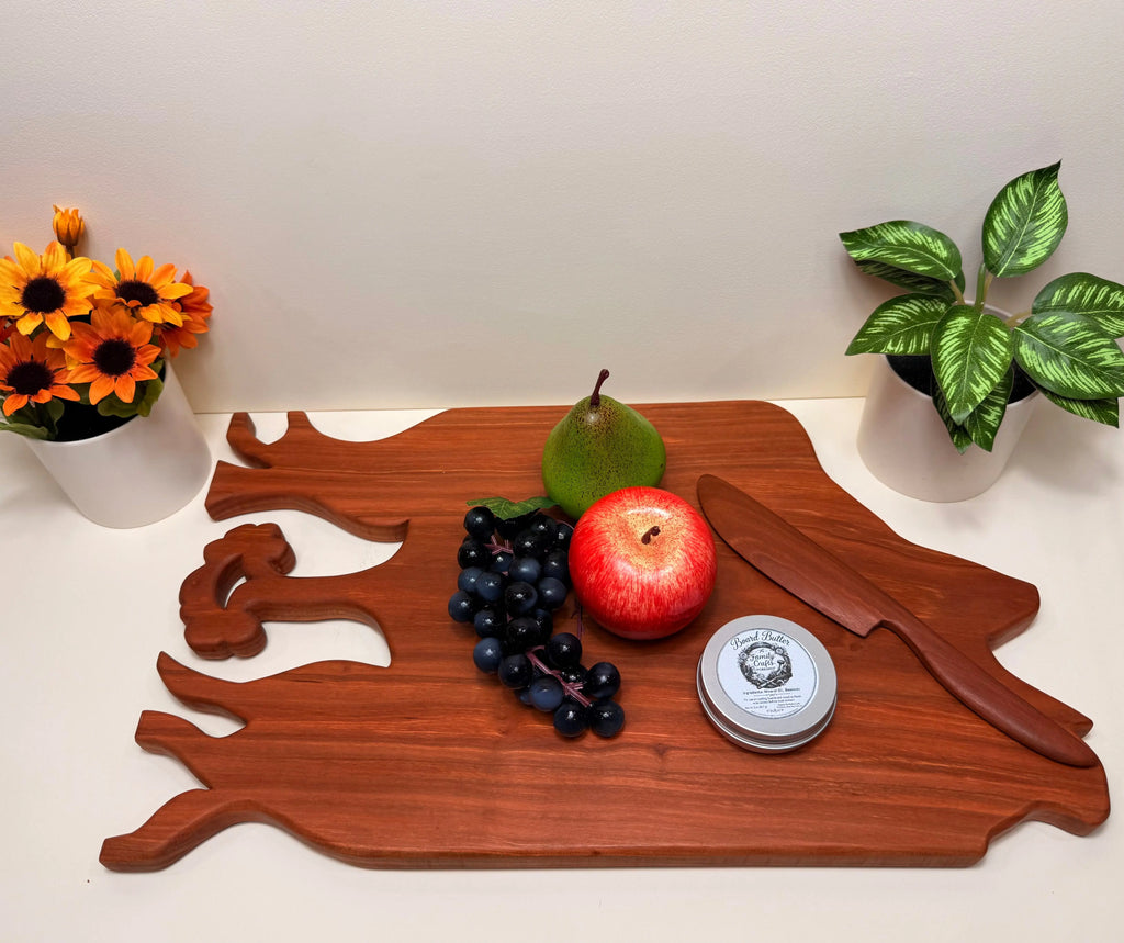 Cherry wood charcuterie board with carved tree motif and cutout handles