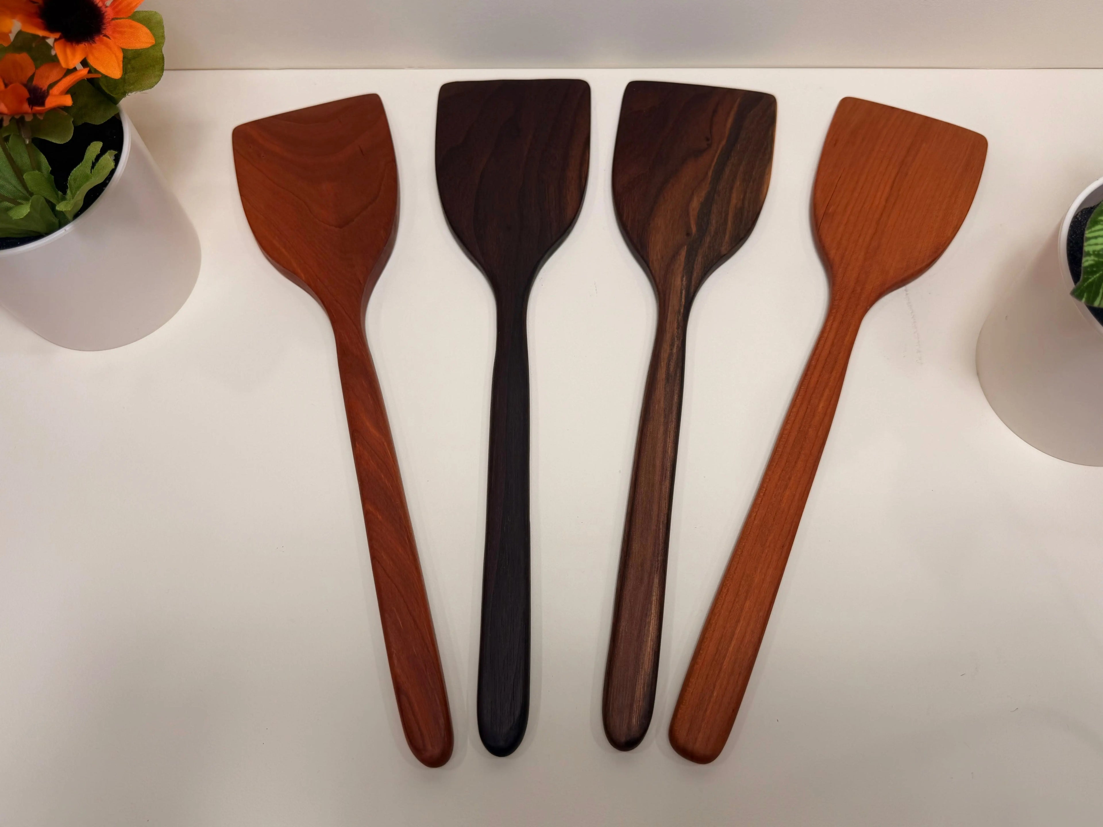 Handcrafted wooden kitchen utensils, four walnut and cherry spoon-spatulas with rounded tips