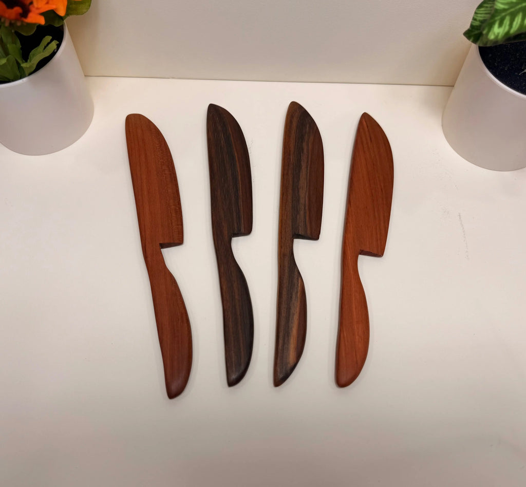 Wooden butter spreaders with tapered handles in cherry and walnut tones