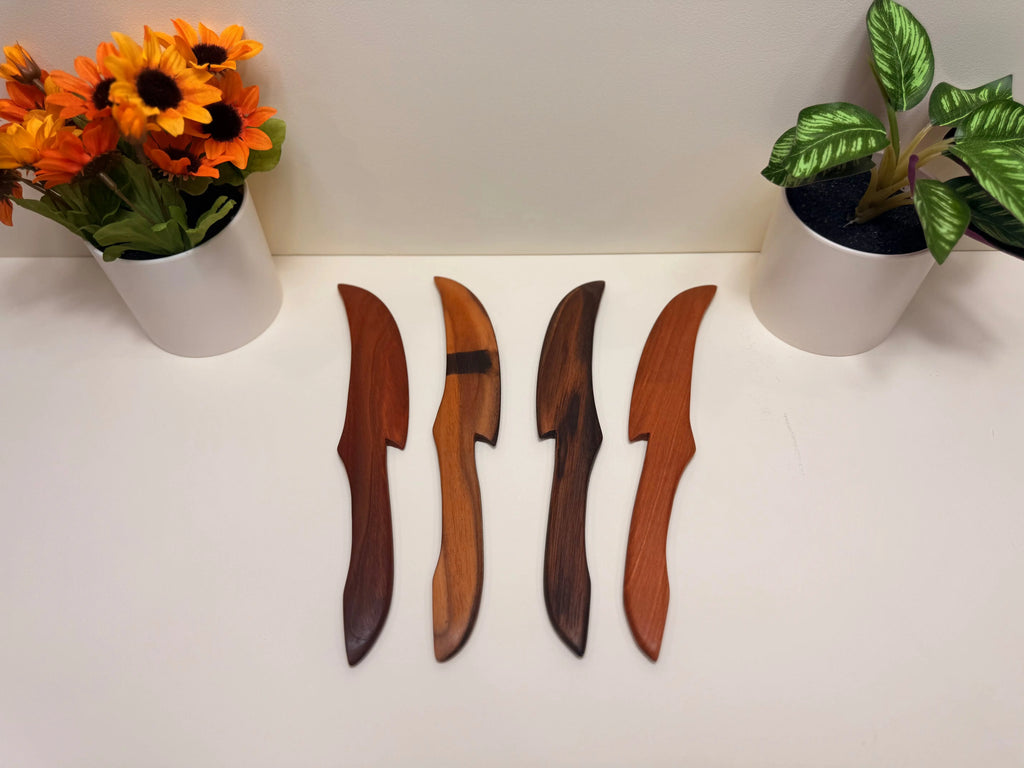 Wood butter spreaders with carved leaf-shaped blades, set of four.
