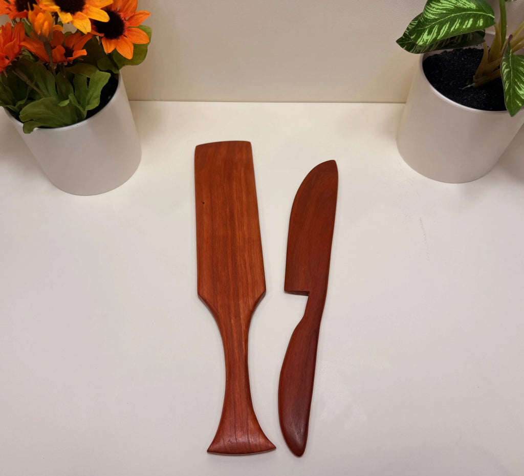 Reddish-brown wooden butter spreader and spurtle, paired kitchen utensils