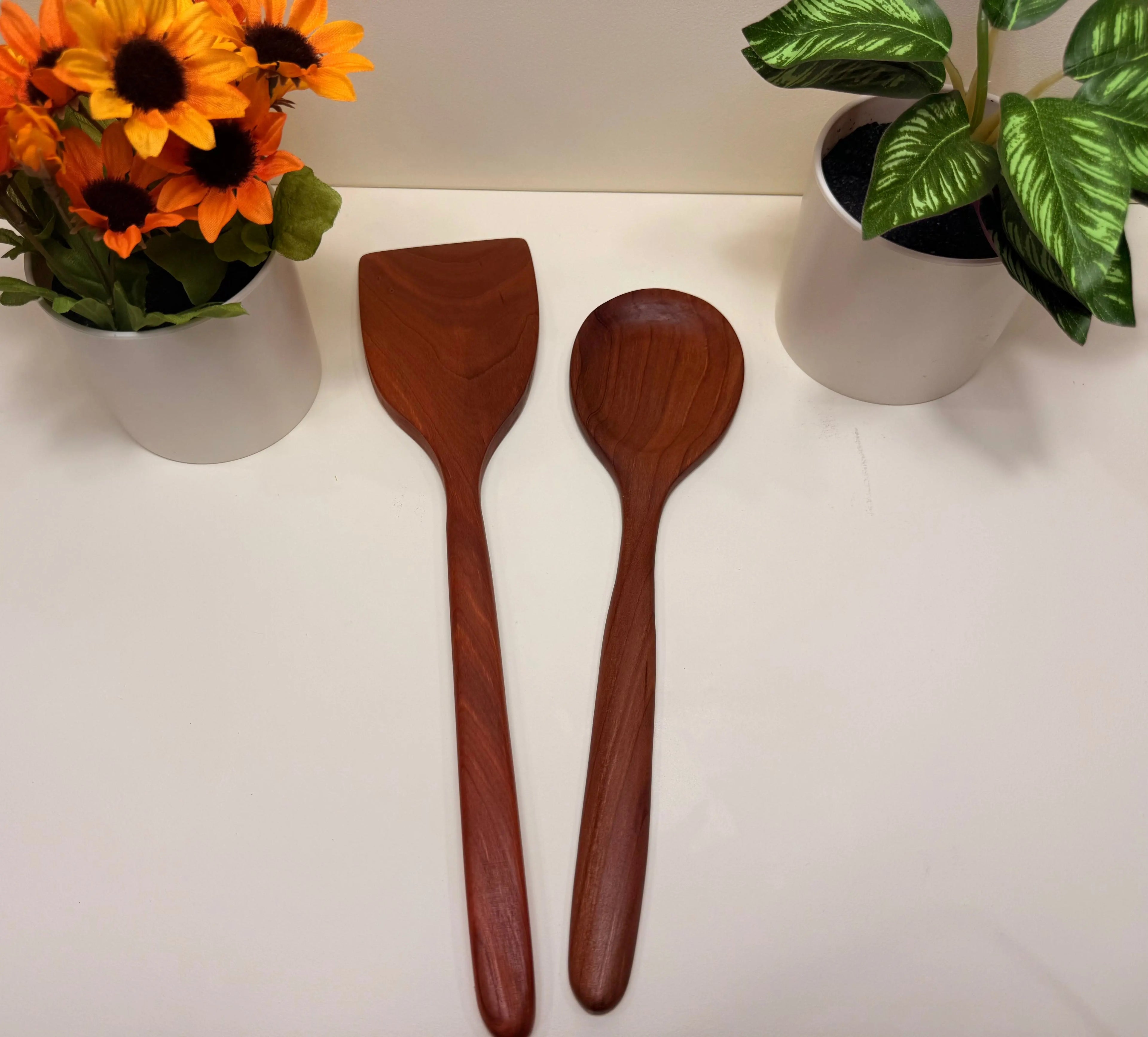 Handcrafted wooden kitchen utensils, two walnut and cherry spoon-spatulas with tapered handles