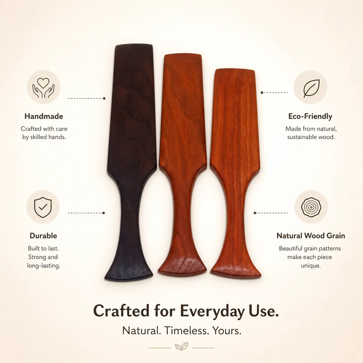 Three wooden spurtles side by side, dark and two reddish-toned finishes.
